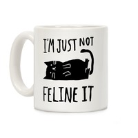 https://images.lookhuman.com/render/thumbnail/qVr8jZ0O9WLudg9MX1jVDRbjaj8TMt2S/mug11oz-whi-z1-t-i-m-just-not-feline-it-cat.jpg